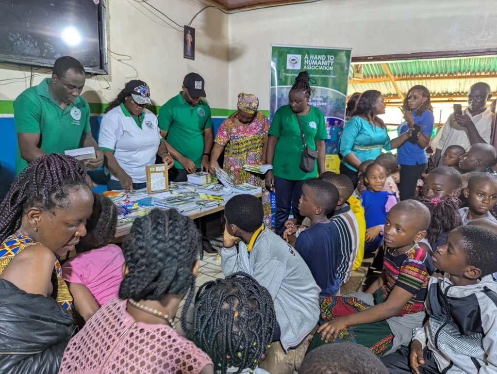 Children receiving school kits when you donate to help children in Cameroon through A Hand to Humanity